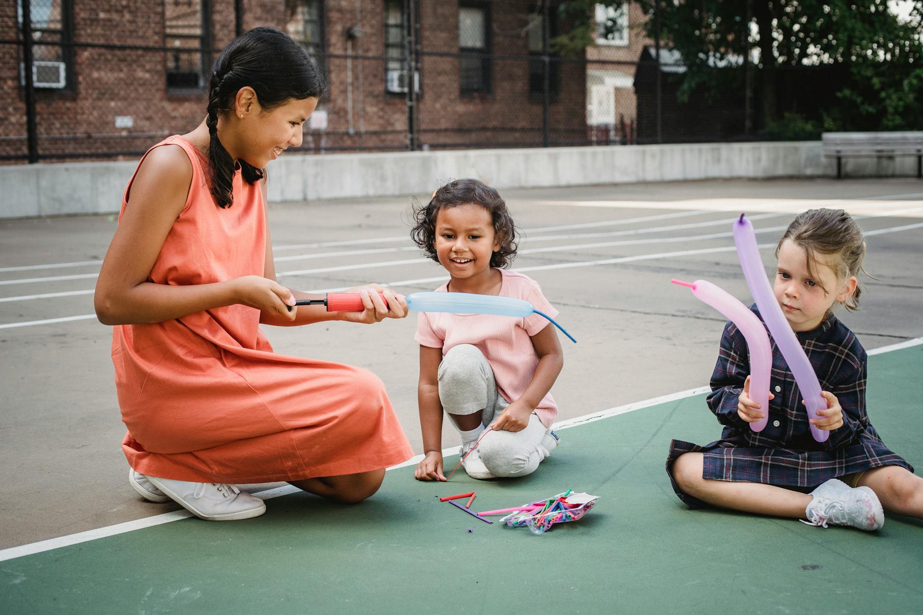 Children playing outdoor party games in a decorated backyard with relay races and lawn activities